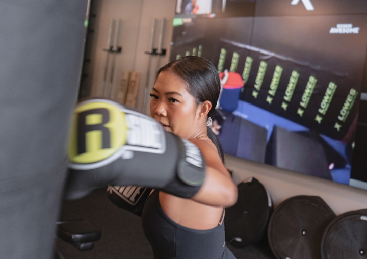 woman punching a heavy bag